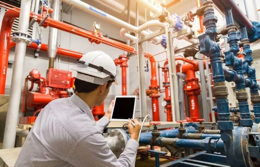 a man inspecting a fire safety system