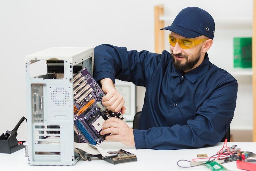 image showing a man detaching a motherboard from a CPU