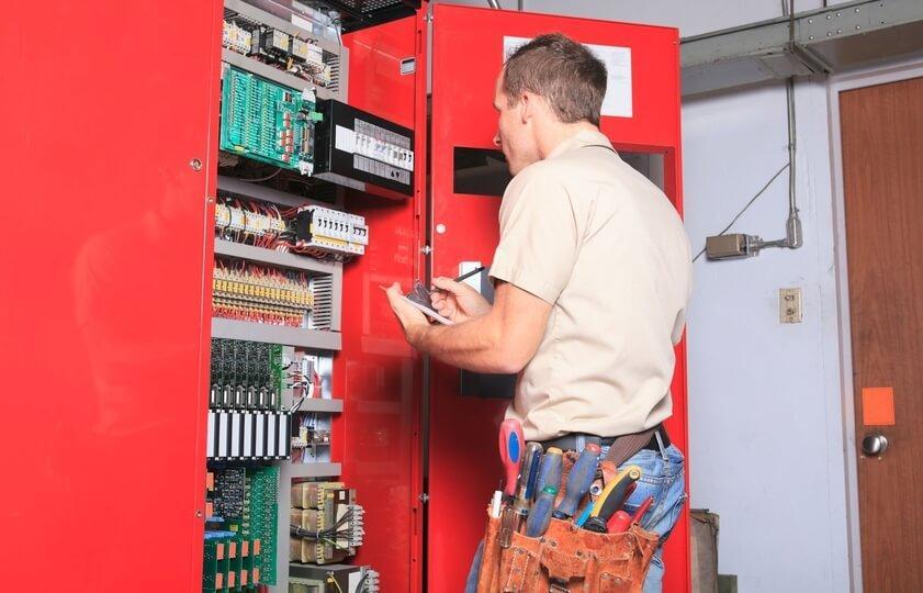 man inspecting elevator system